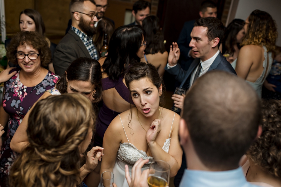 A bride dancing with her friends at her wedding reception.